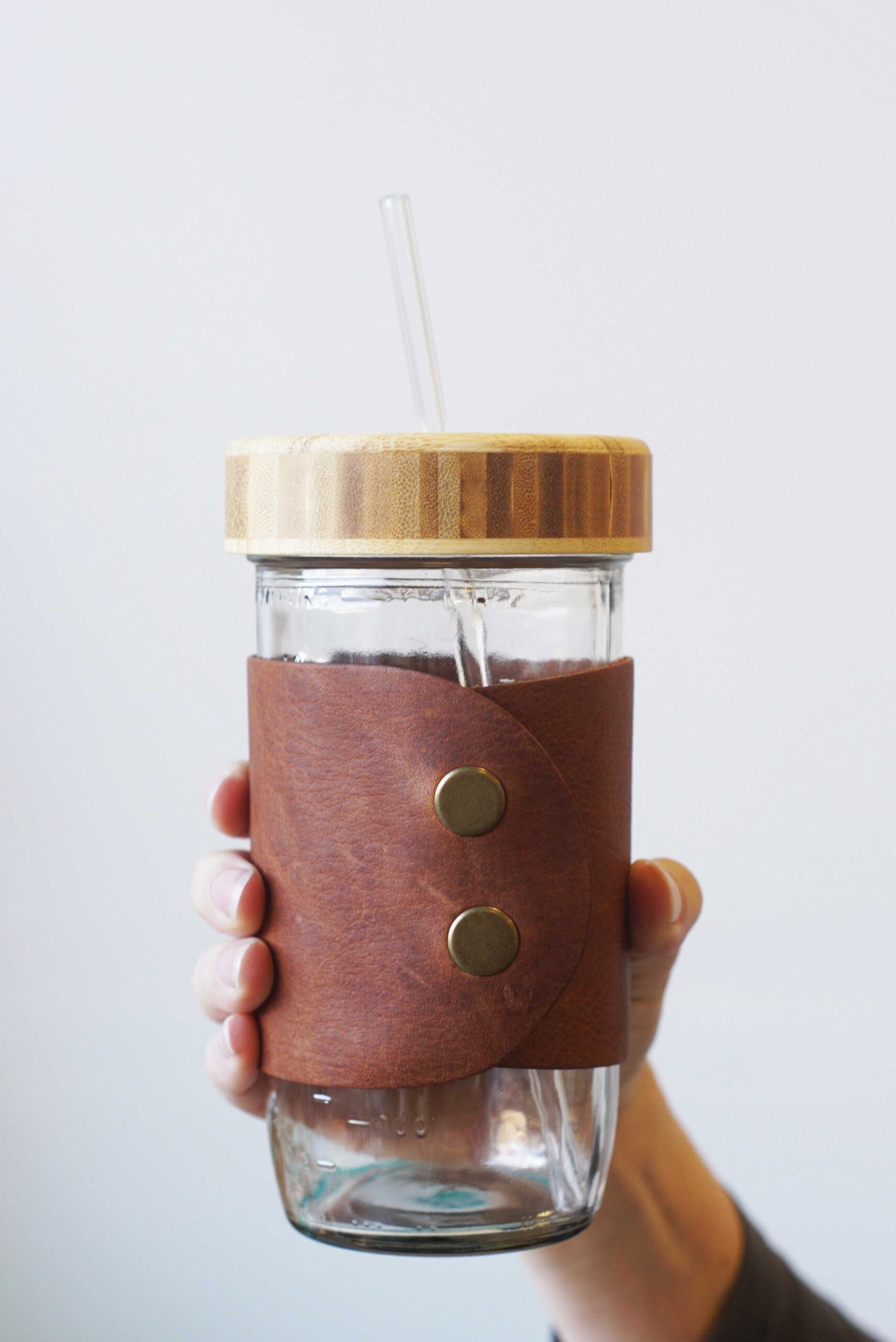 Available in a variety of colors and materials, the mason jar cuffs from Mason Bar Company wrap around mason jars and make for a great rustic touch at receptions.